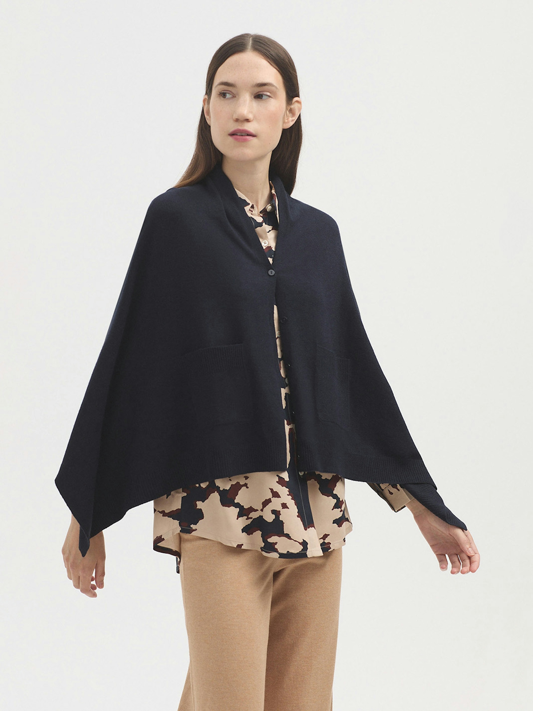 Cape with buttons and pockets
