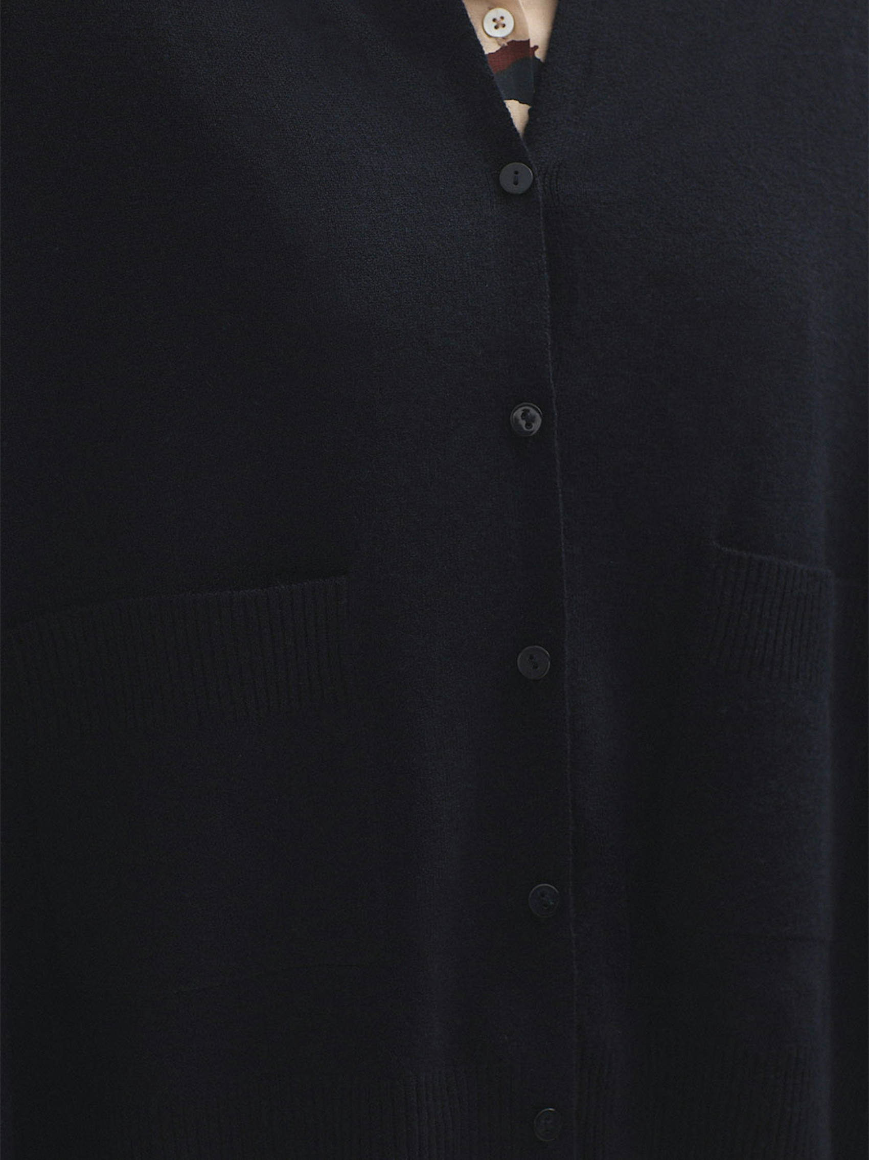 Cape with buttons and pockets