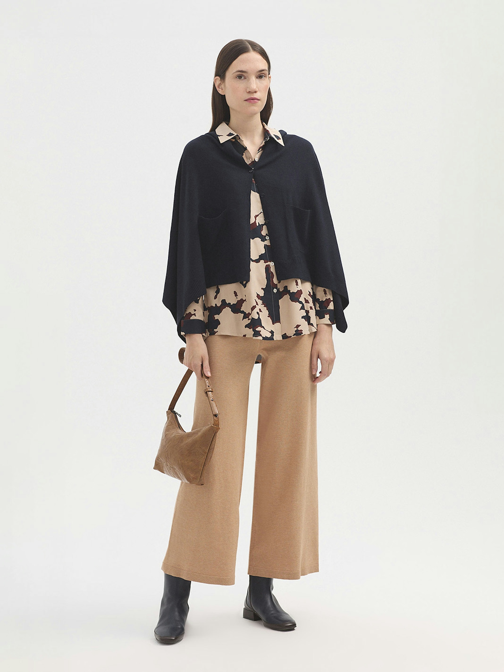 Cape with buttons and pockets