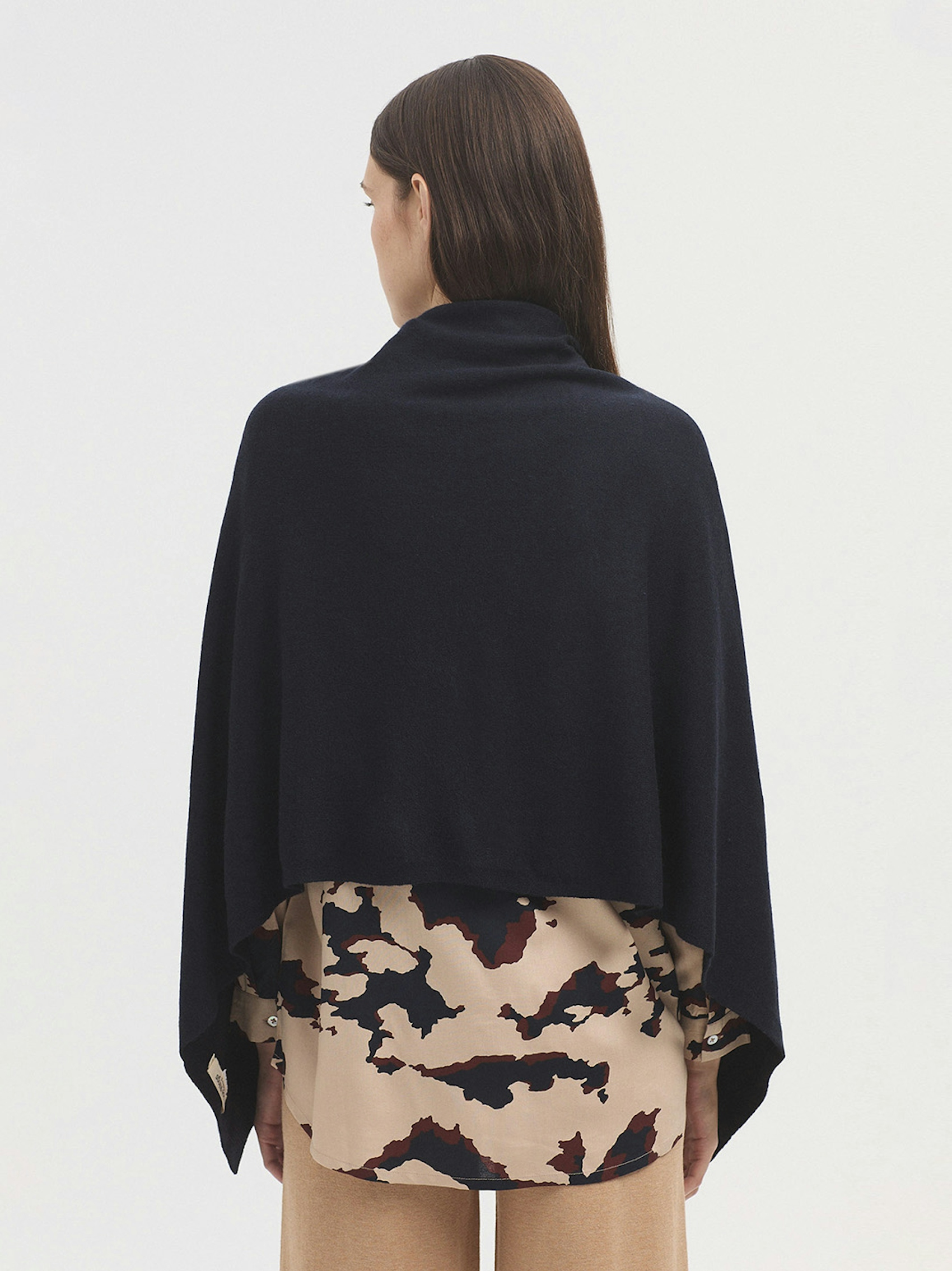 Cape with buttons and pockets