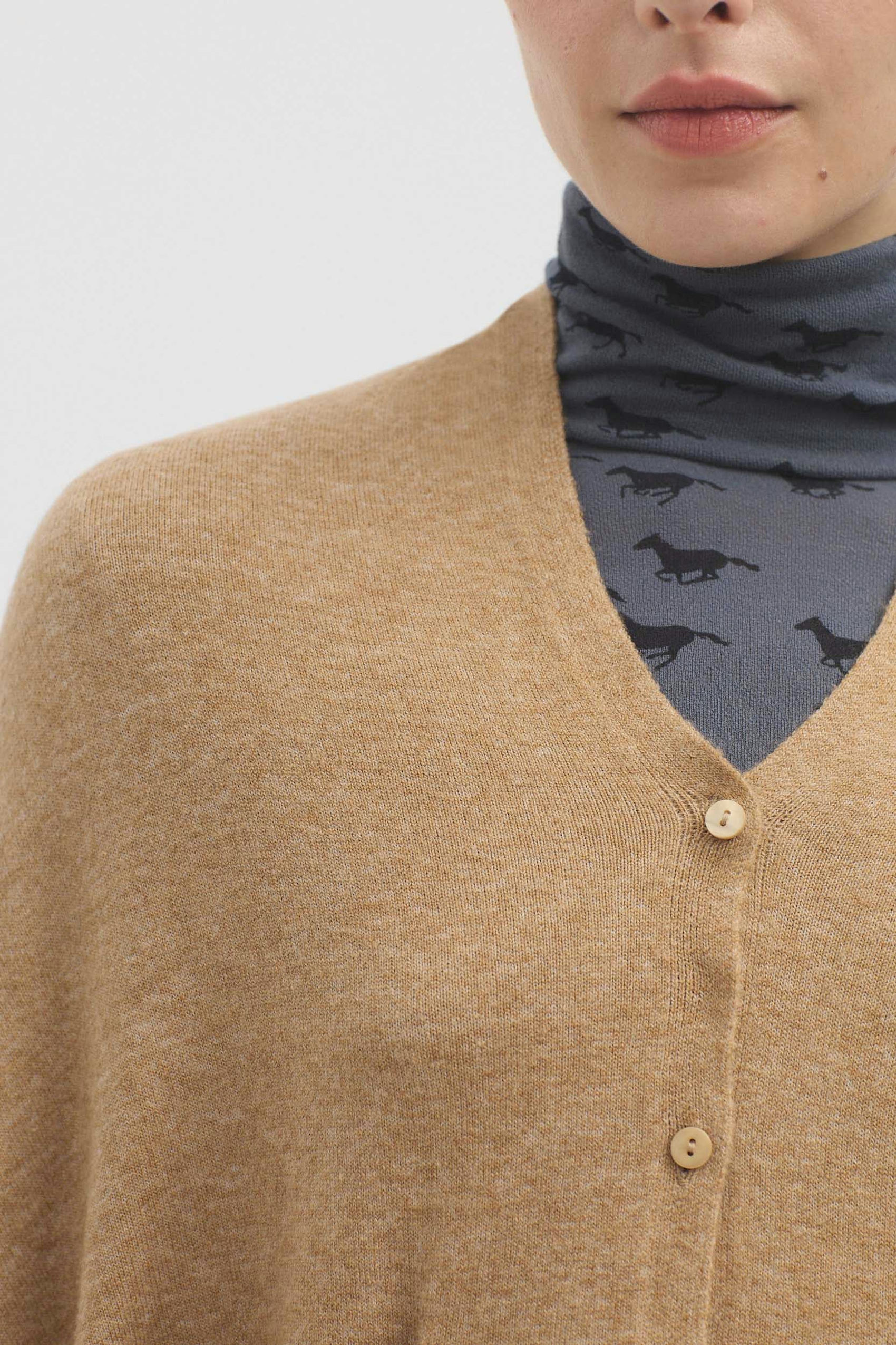 Cape with buttons and pockets
